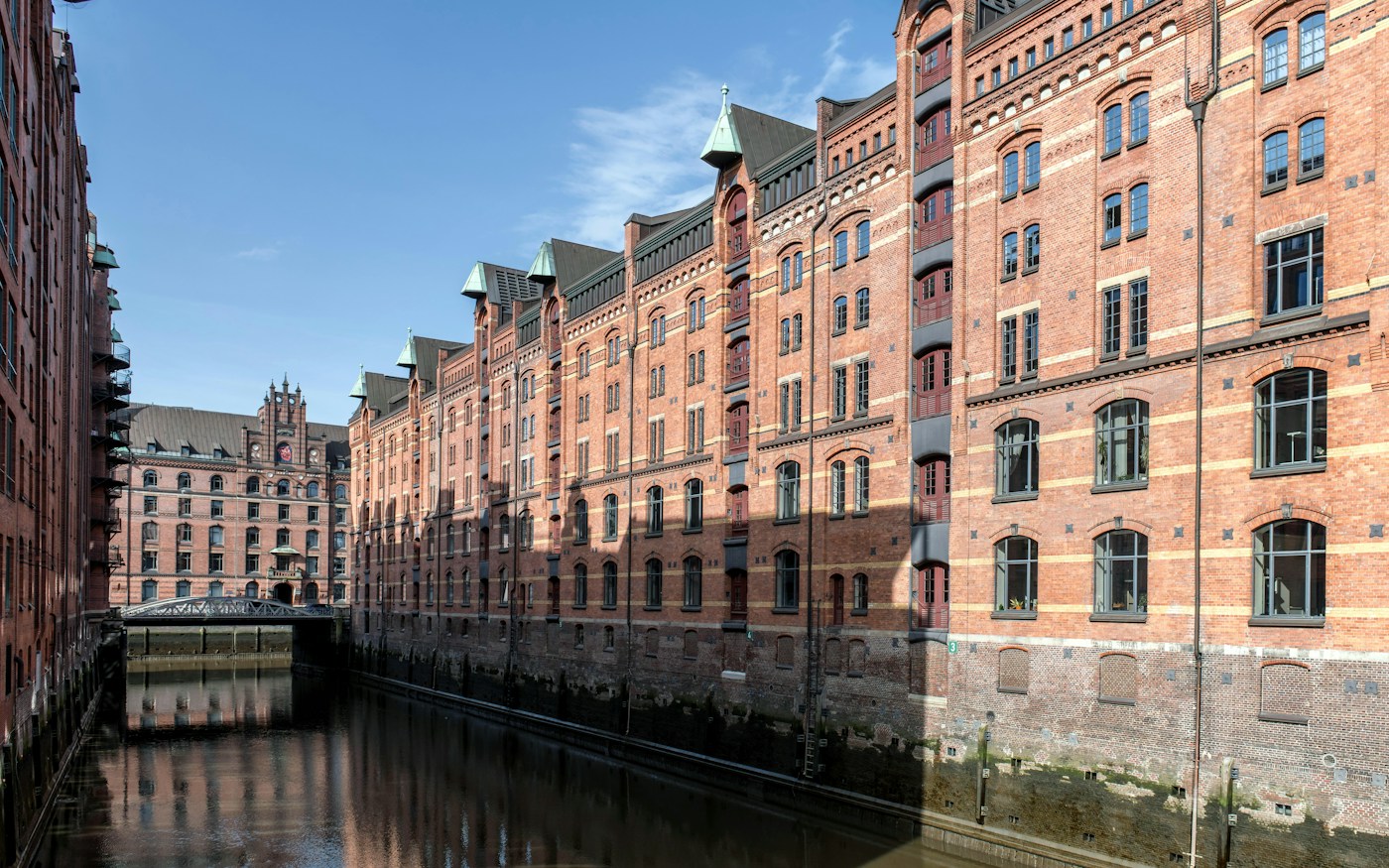 Red brick warehouses beside a canal in Hamburg’s Speicherstadt